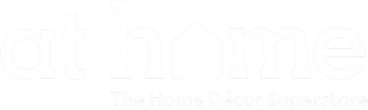 White logo text reading 'at home' with a house icon inside the letter O, and the tagline 'The Home Décor Superstore' below on a white background.