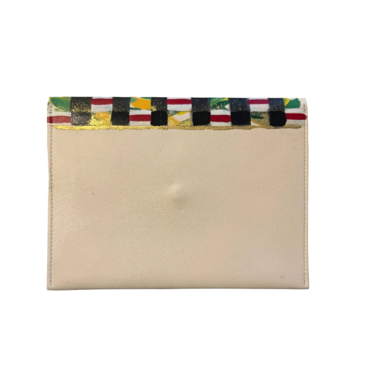 A cream-colored leather card holder or wallet with a colorful patterned paper trim along the top edge, resting on a gray marble surface.