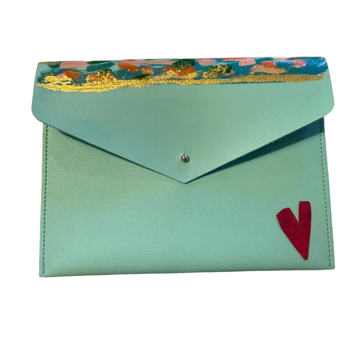 A light blue envelope-style wallet or clutch with a colorful floral patterned trim along the top flap, a small silver snap button, and a red heart detail on the front. A hand with red-painted nails rests near the bottom left on a light marble surface.