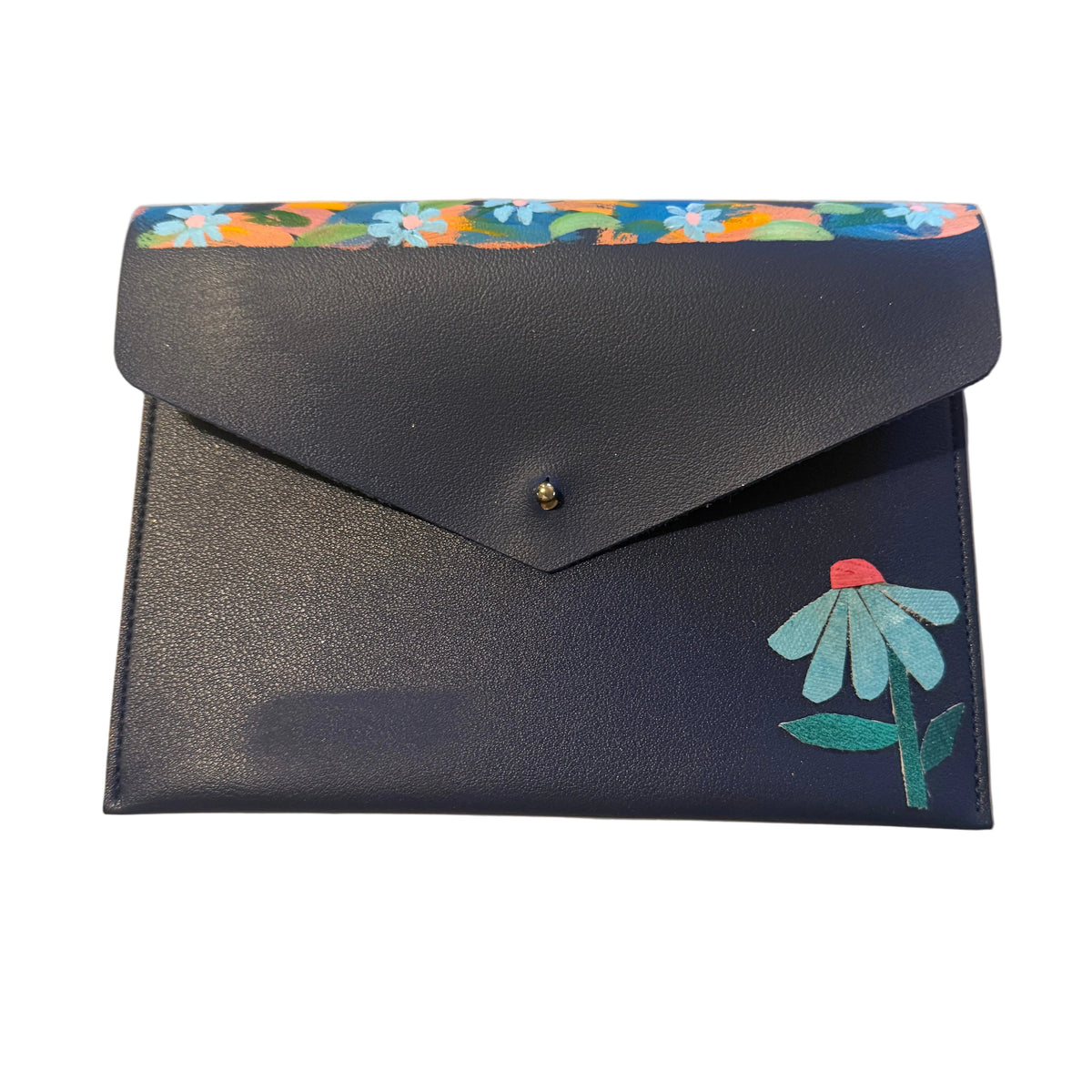A navy blue envelope-style wallet with a colorful floral pattern along the top flap edge and a painted light blue flower with a red center on the front, placed on a light marble surface.