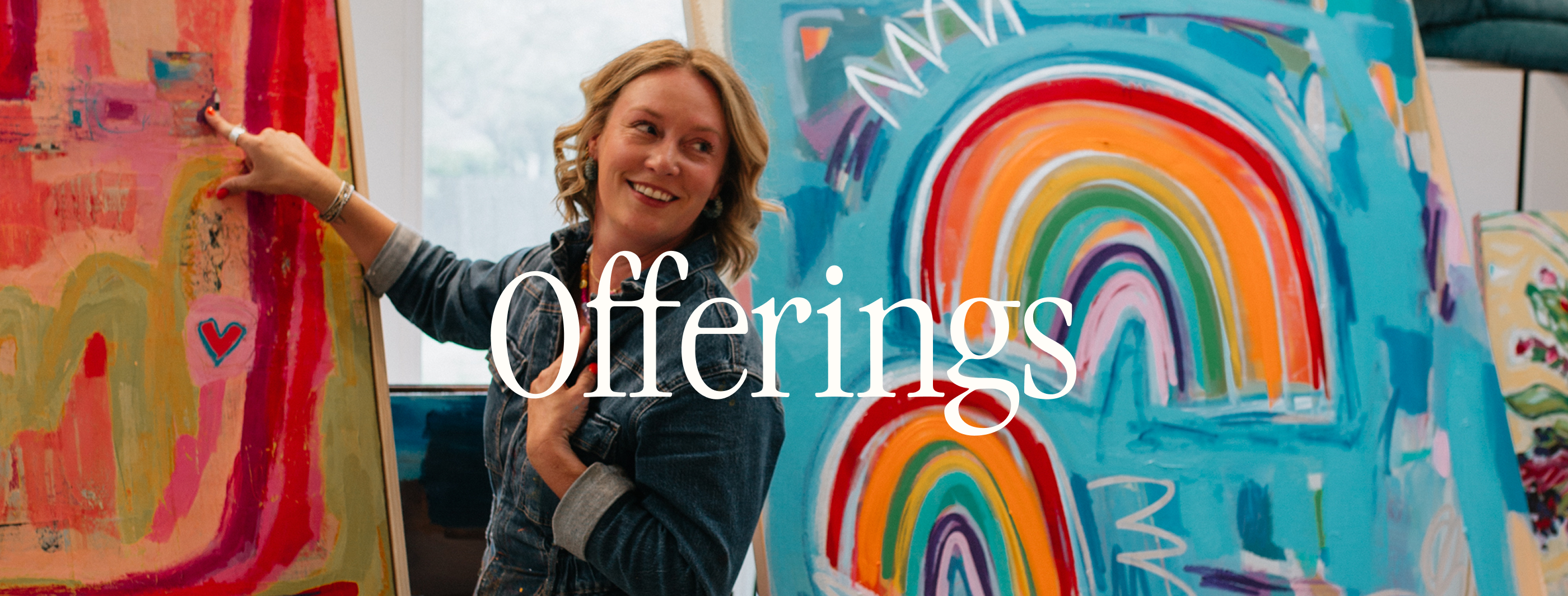A smiling woman stands between two colorful abstract and rainbow paintings in a bright studio, with the word 'Offerings' overlaid across the center.