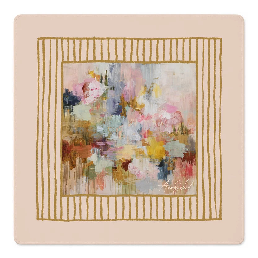 A square decorative art print or canvas featuring an abstract floral painting in soft pastel tones, surrounded by a gold striped border on a pale blush background. The signature 'Anna Sokol' is visible in the lower right of the artwork.